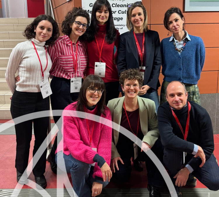 Researchers in front of Greener Cleaning Methods for Cultural Heritage workshop poster